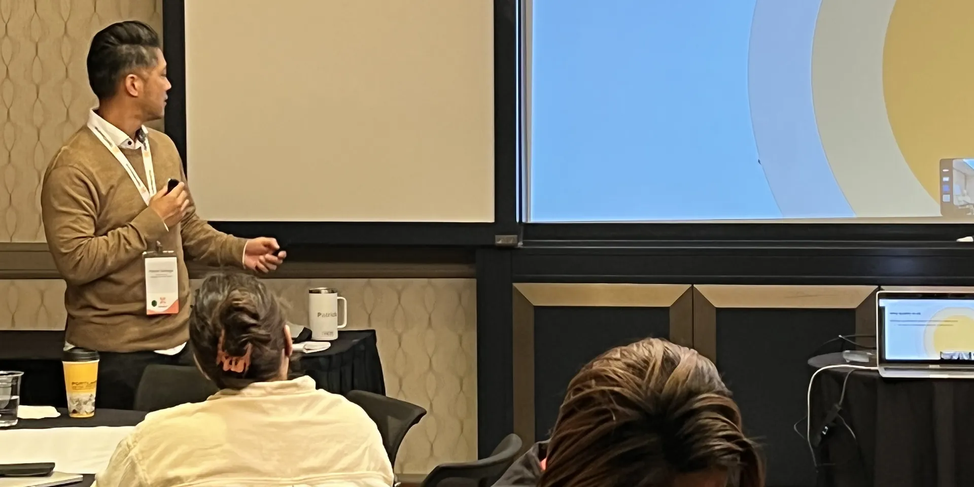 Patrick Santiago teaching a room of people from a slide about qualifying opportunities with MEDDIC